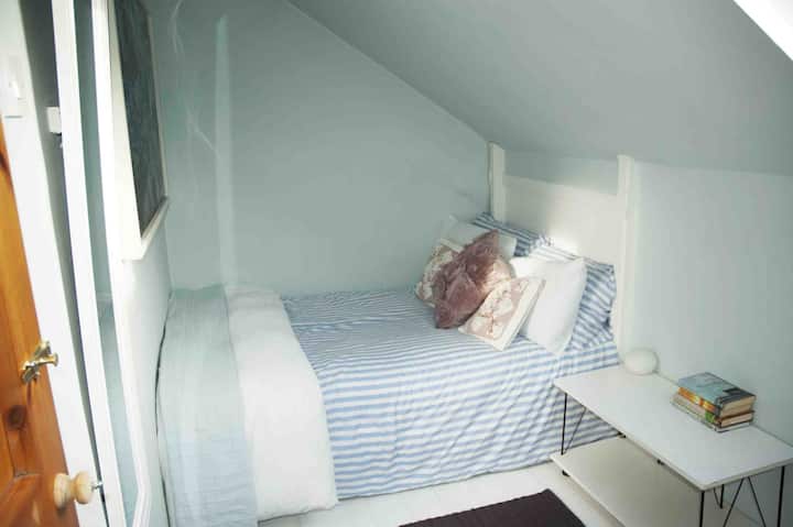 Cosy double bedroom with wardrobe and rocking chair.