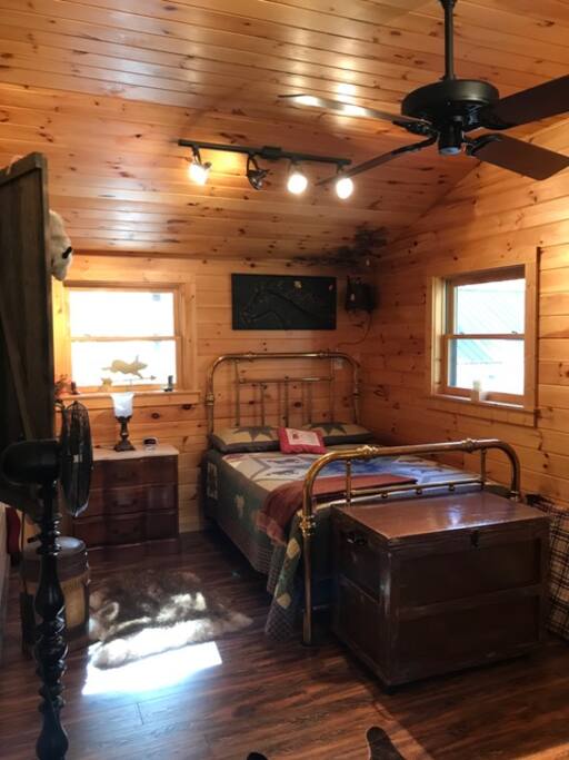Sleeping/living area; foot of bed faces couch