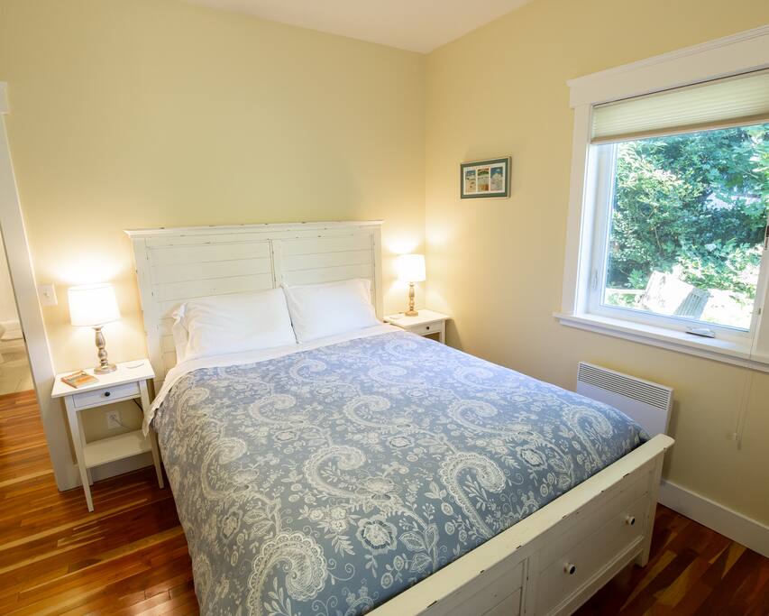 Queen bedroom with window facing back yard.