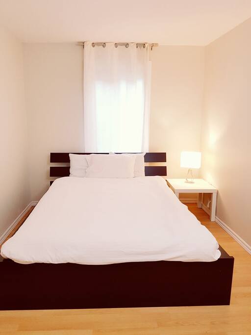 Nice and warm bedroom with a big comfortable queen bed.
