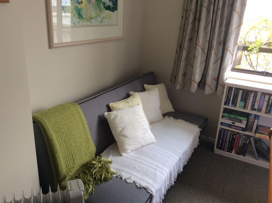 A couch to sit or put your suitcase on.