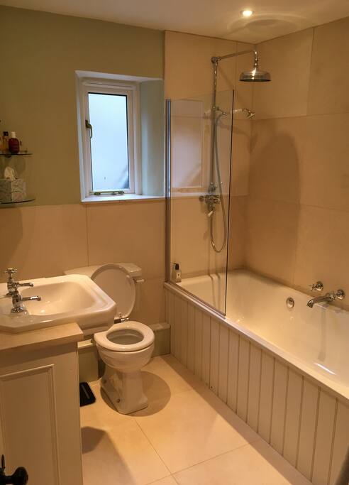 Natural stone tiles and a large Betty bath give you a wonderful shower or bath.
