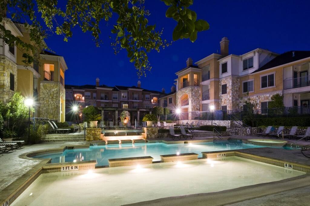 Pool area with jacuzzi, sand volleyball court & fire pit