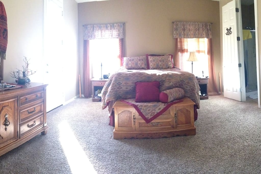Spacious master bed with queen pillow top bed and access to cozy, private back patio (door on left)