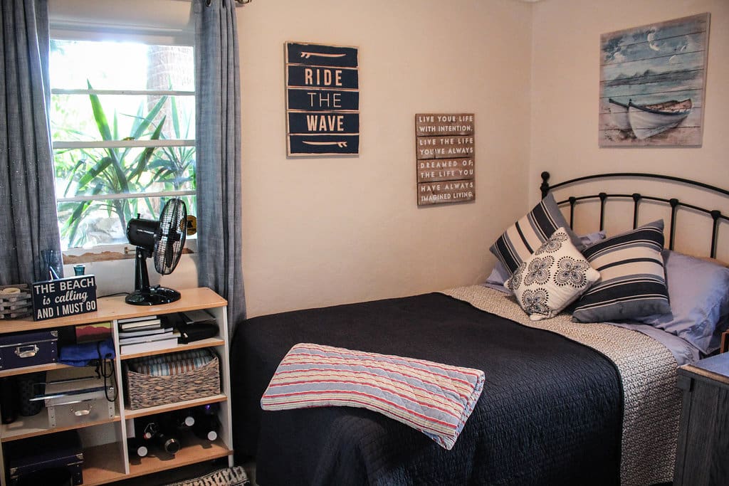 This is the private bedroom. It is a full bed with an attached bathroom. There is a large flat screen TV in the room, with ample bureau storage. Windows look onto the deck/pool area.