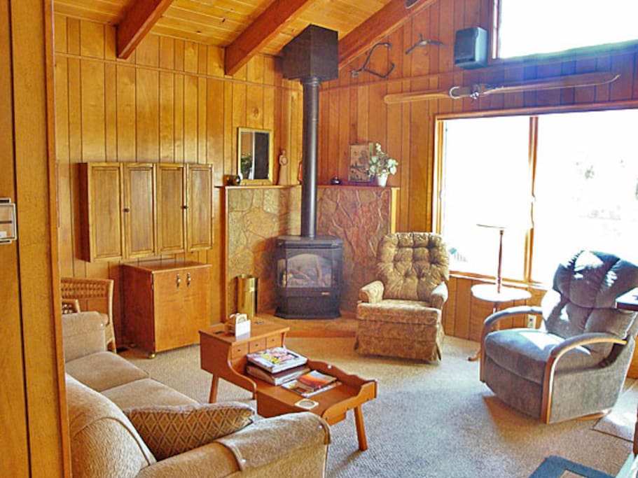 Living room with exposed beam cathedral ceiling and gas fireplace.