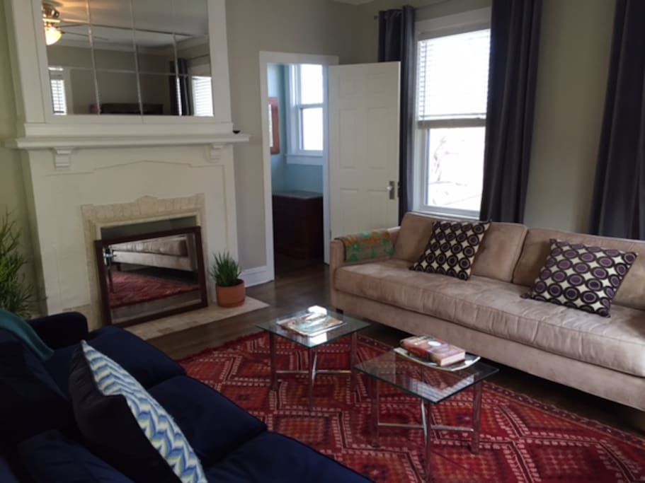 The living room, dining, and kitchen are all one open floor plan. There are two couches facing each other for conversation and relaxing.
