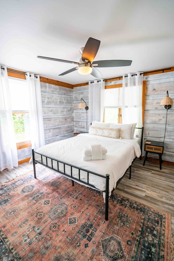 Main floor bedroom with closet and full bath.  Each bedroom has a heater, floor fan and a luggage rack(s).