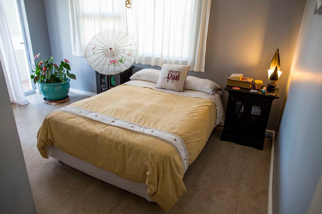 Guest bedroom with double bed on second floor of home with own door to the balcony
