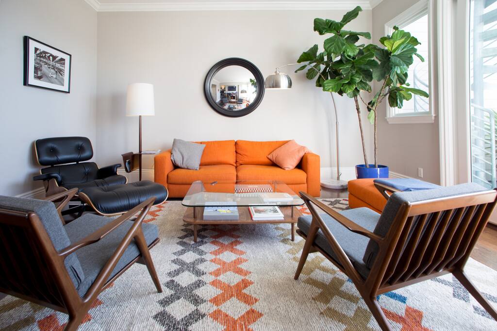 Living Room: original Eames Lounge Chair on the left, danish vintage chairs and lamp. The black and white picture on the wall is by Gianni Berengo Gardin, italian world renowned photographer, original and signed on the back.