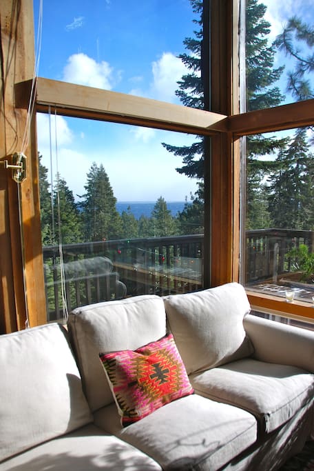 Sun-drenched lake view living room.