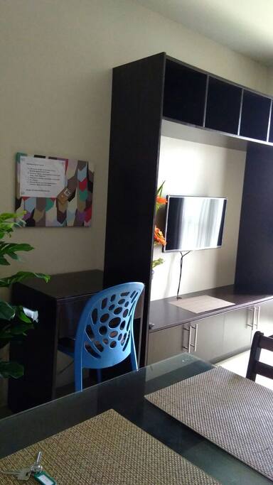 Working desk beside wall-mounted LCD TV