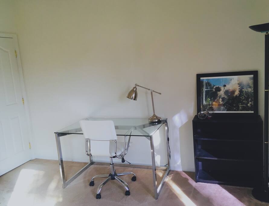 Extra bedroom and side office with workspace, comfortable chair, charge station, laser printer, book shelf, plenty of natural light, and fresh air.