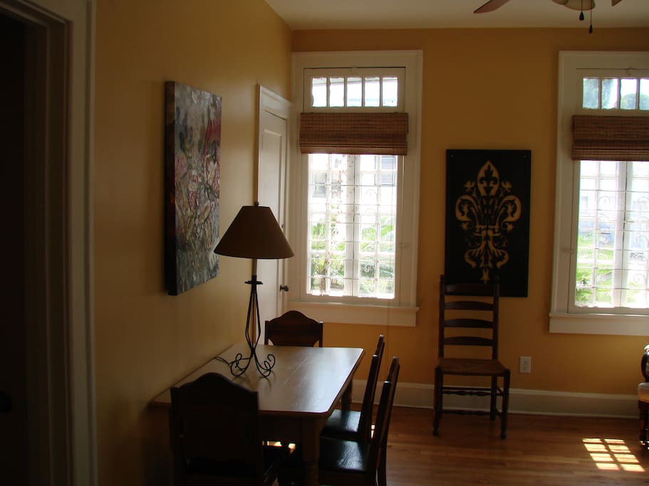 This is a cozy sitting room right off the kitchen with windows at the front of the house. Also, a drop leaf table for dining .