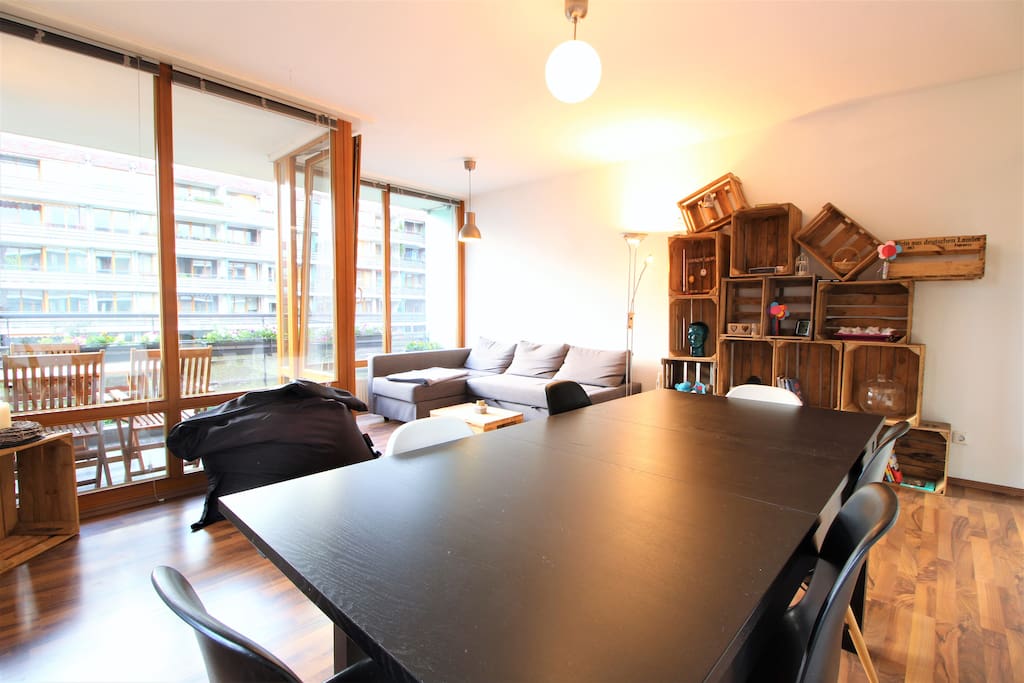 The beautiful furnished, bright living room has a modern design & a cozy couch.