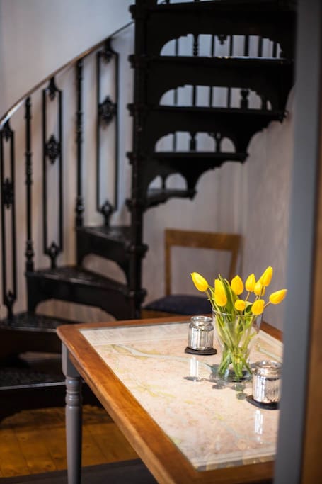 Dining area with spiral staircase.