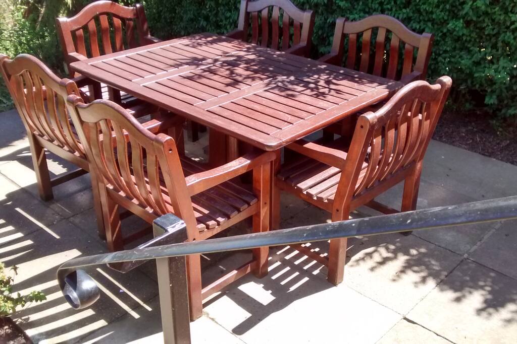 A set of steps leads to the outdoor dining area , there is also a bistro set on the patio