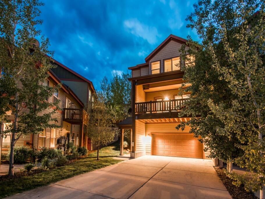 Two car garage and deck at dusk.