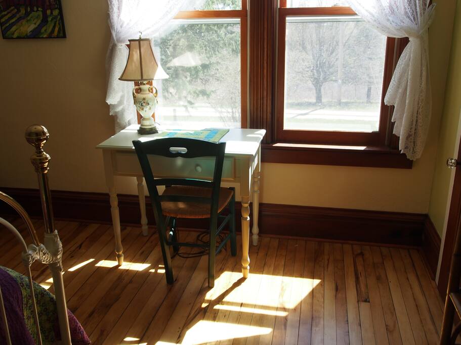 The room has a small desk with a nice view.