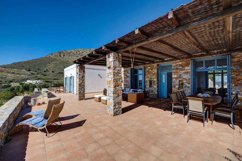 Large veranda with seating and outside dinning area of the main house