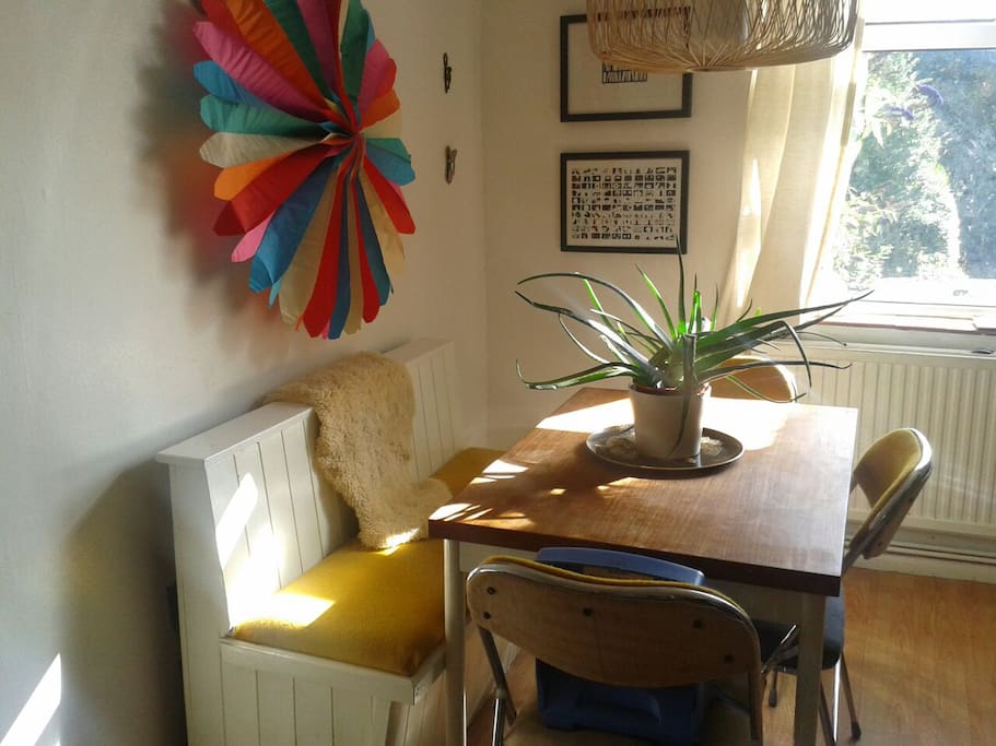 Shared living room with dining table, sofa, T.V. & DVD player, are available to guests in the morning.