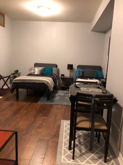 Beds, luggage rack & small breakfast table.
