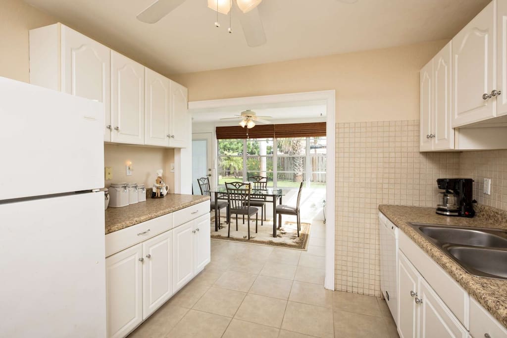 Spacious kitchens leads to sunny Florida room.