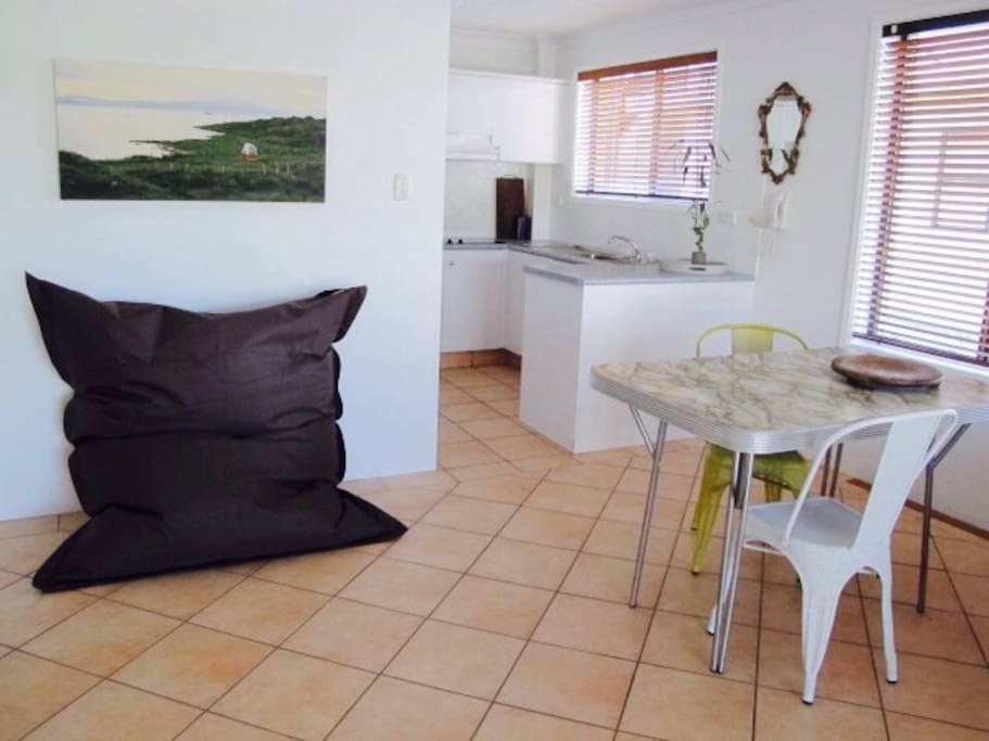 Dining area flows into kitchen. Is this the biggest beanbag you've ever slept in?