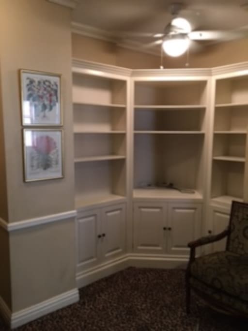 Freshly painted shelves and cabinets hold convection toaster oven, microwave, Keurig coffee maker and mini-fridge and lots of storage space