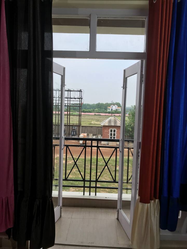 Way to balcony to catch view of extensive open green fields