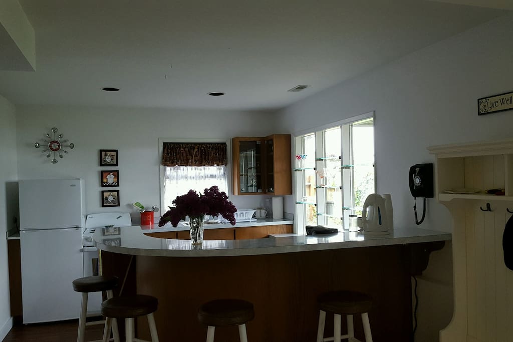 Bright kitchen space with view and breakfast bar with seating for 4.