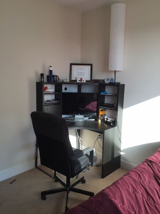 A study/work desk with a comfortable chair.