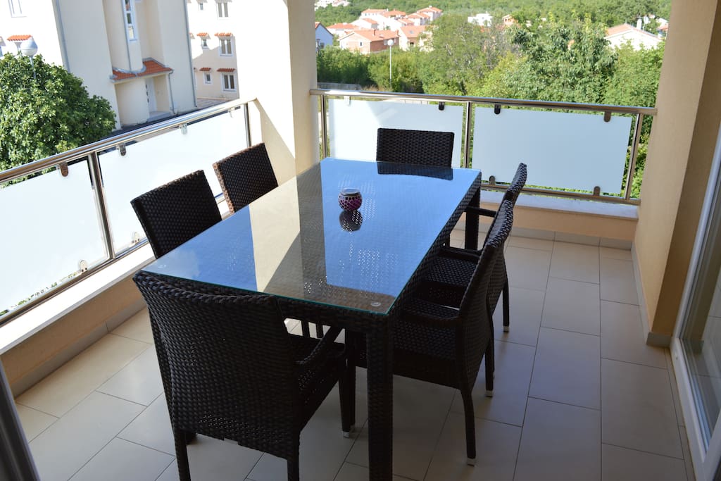 Large balcony with 6 people dining table