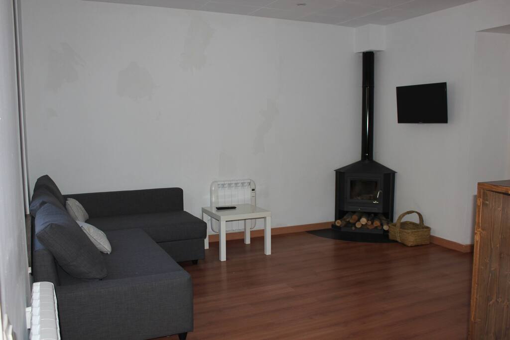 Sofá cama y chimenea.