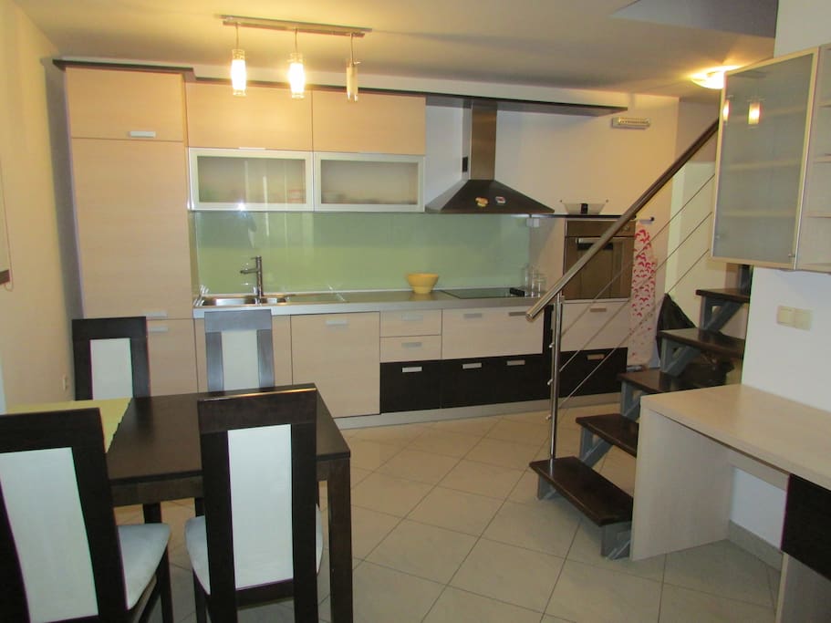 Spacious kitchen with cookware and tableware.