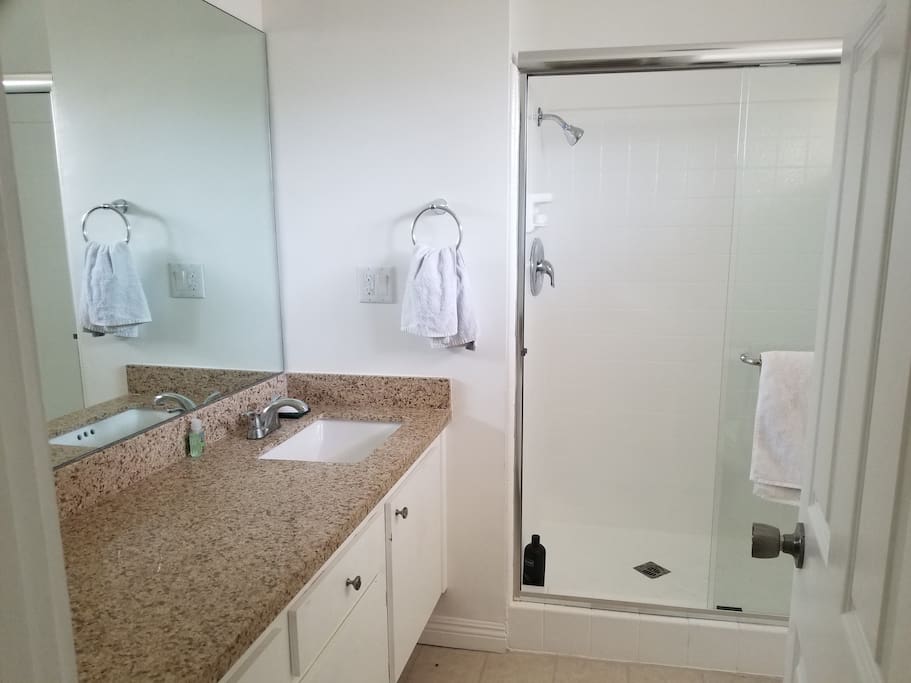 Private bathroom, towels, shampoo, soap.