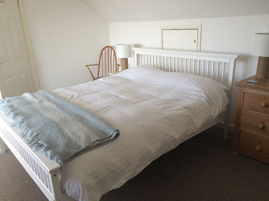 Light filled bedroom one. See the ocean and beach without leaving the cosy kingsize bed.