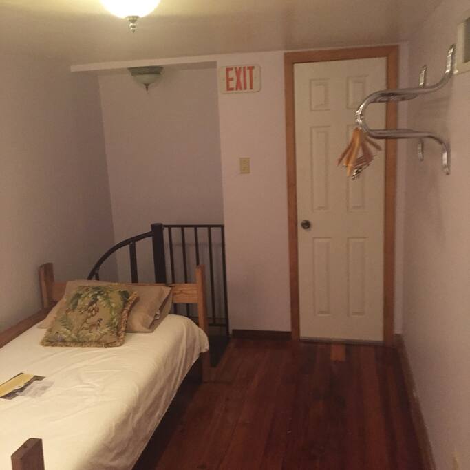 Third floor with 3 single rooms and a half bath, living room area down on second floor