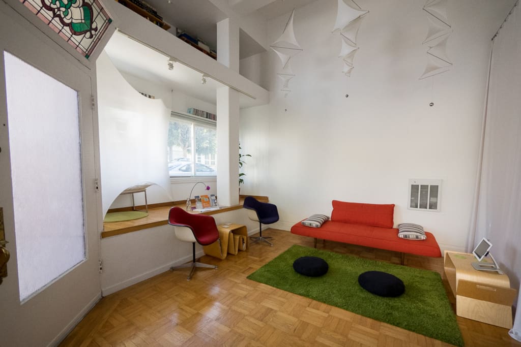 Living room with modern decor and sculptures.