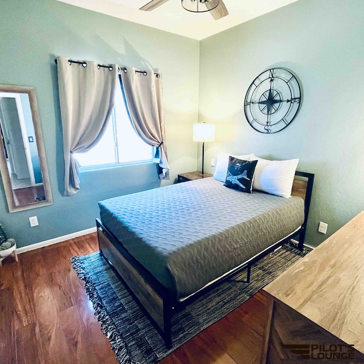 Co-Pilot Bedroom: Full bed, dresser, nightstand with USB charging port, closet with hangers and luggage racks, spare aviation blanket, full-length mirror, modern ceiling fan
