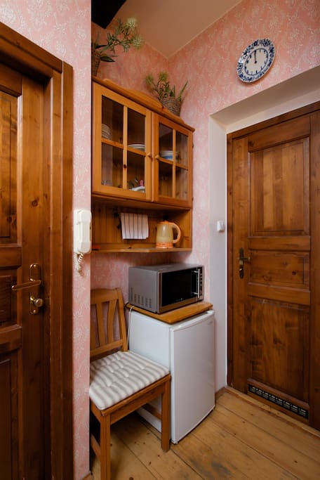 "Kitchen" corner with microwave, mini fridge, electric kettle and utensils