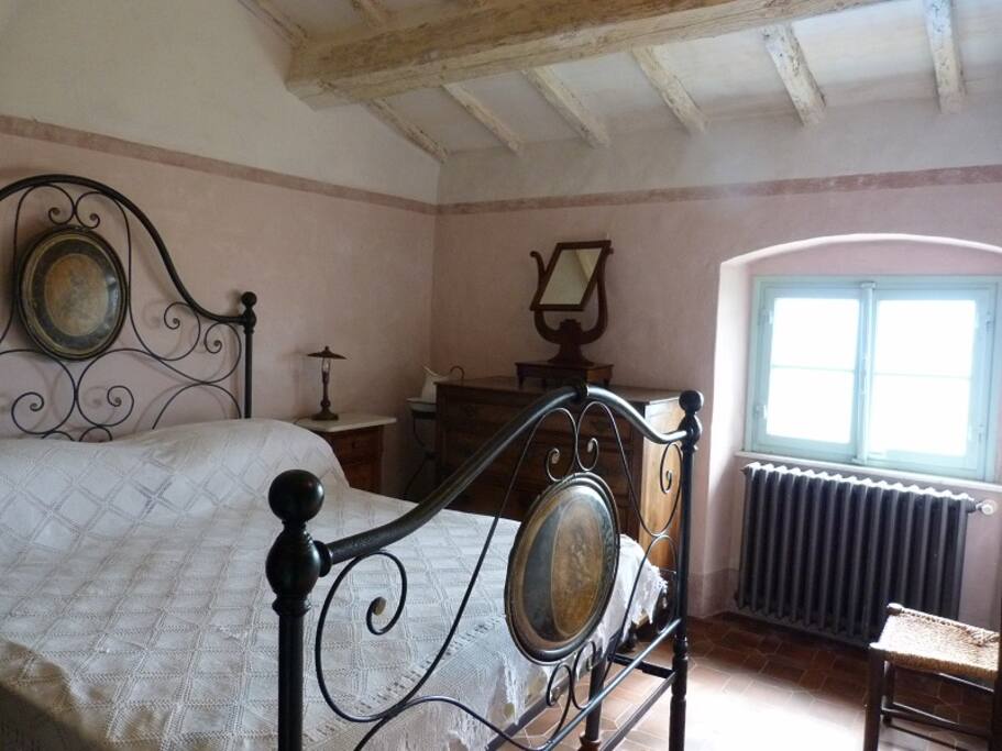 Main bedroom - antique bed. A room with dual aspect and stunning views