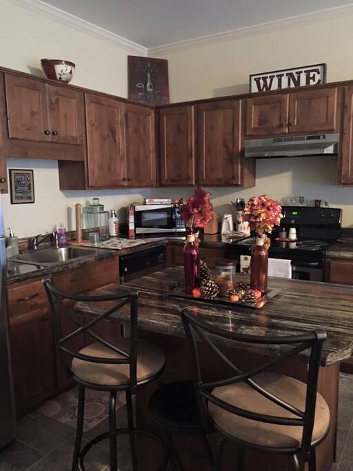Open concept kitchen with bar stools- Stainless Steal Appliances- over-microwave-wine cooler