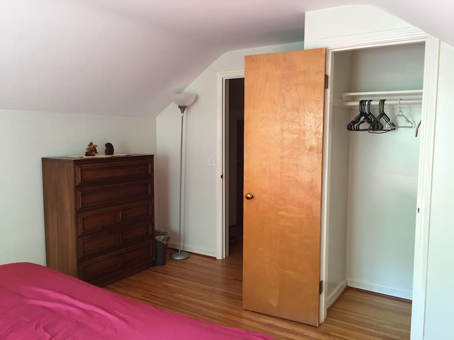 Clothes closet in guest room with hangers.