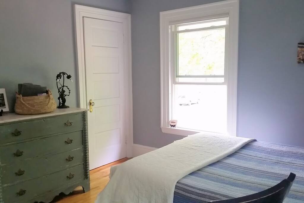 closet and dresser with basket of towels