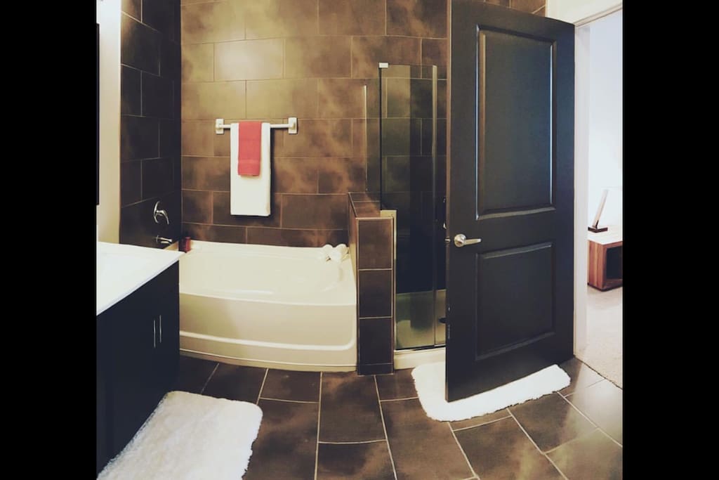 Full size restroom with a bathtub and walk-in shower. Clean towels and toiletries are included