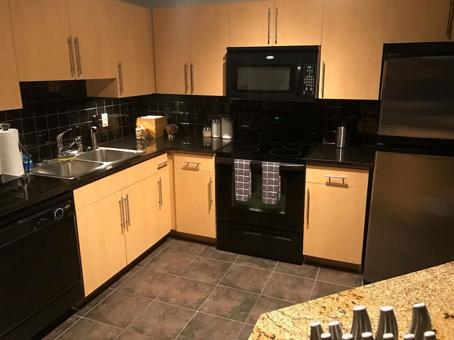 Full size kitchen with island for preparing your favorite dish.