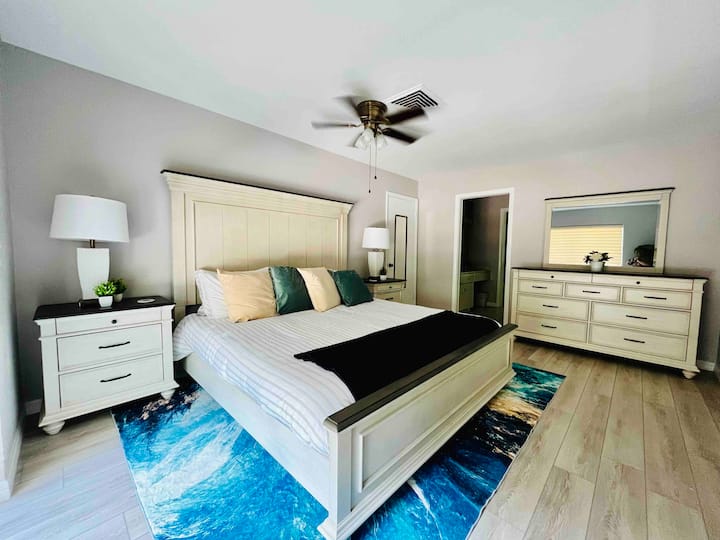 Master bedroom: New king bedroom set, Layla dual-sided mattress (soft/firm). large dresser w/mirror, 2 nightstands. No TV. Wood-look tile. Opens to private bath & screened patio. Note: Photo is outdated. Updated pic coming in April.