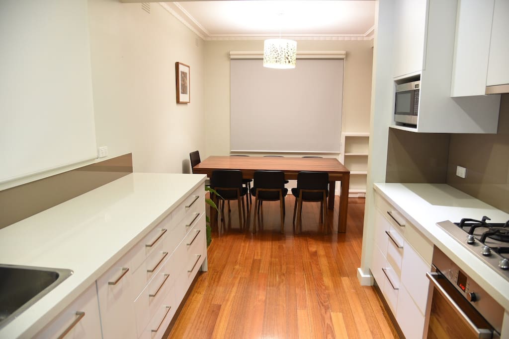 Kitchen with stone benches, dishwasher, oven, fridge, microwave ....etc