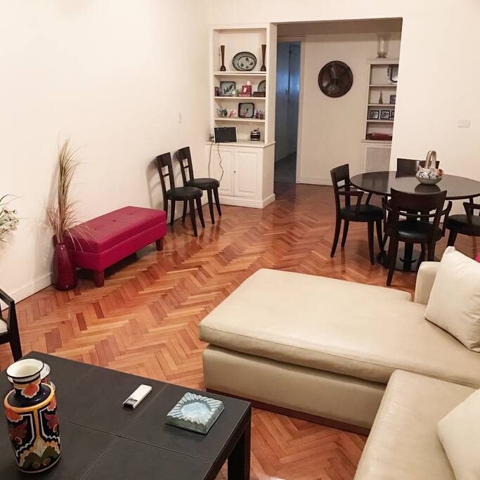 Spacious living/dining room with locally curated furniture and art